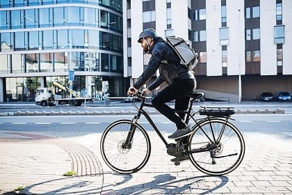 Vue d'un cycliste en zone urbain, utilisateur d'abri vélo extérieur